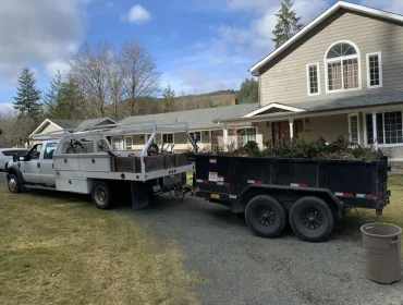 Dump truck and trailer loaded with yard debris
