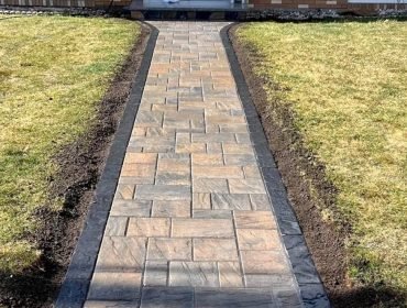 Paver walkway installed through a lawn