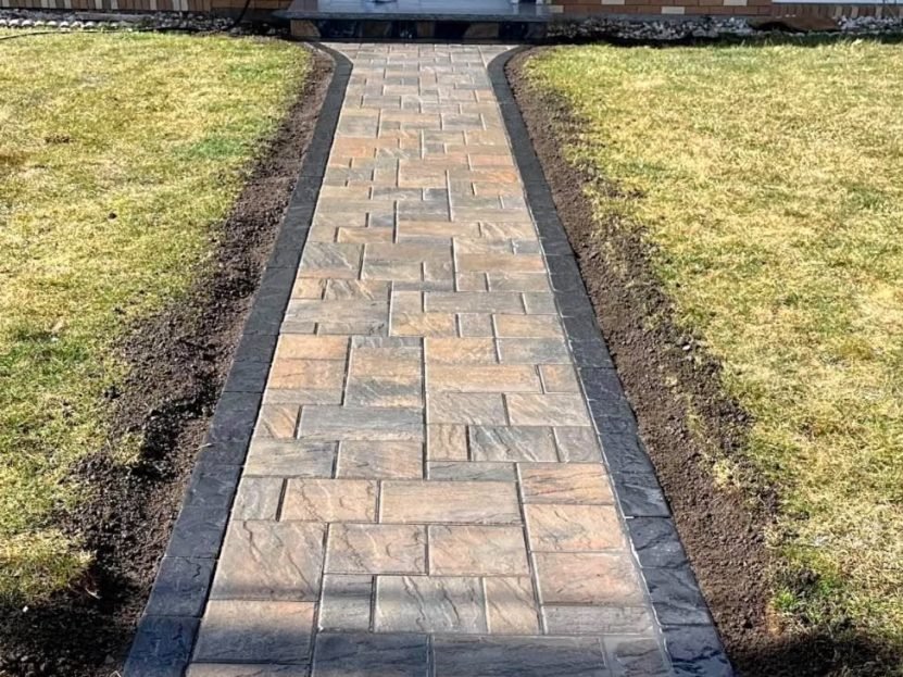 Paver walkway installed through a lawn