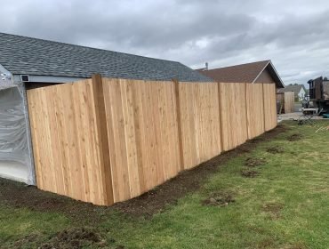 Cedar privacy fence along a backyard property line